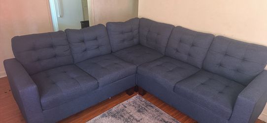 Small sectional and fireplace entertainment center