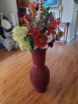 Tall wicker vase with colorful silk flowers