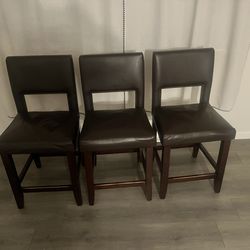 Brown leather and wood stools
