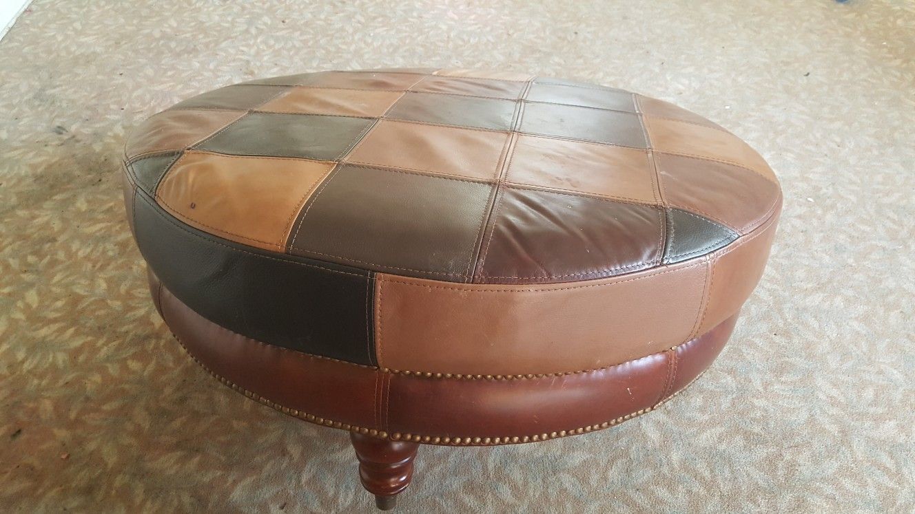 Very large round leather ottoman coffee table stool, one leg needs put back on, not a biggie. Secret zippered pouch underneath for your stash. 38"