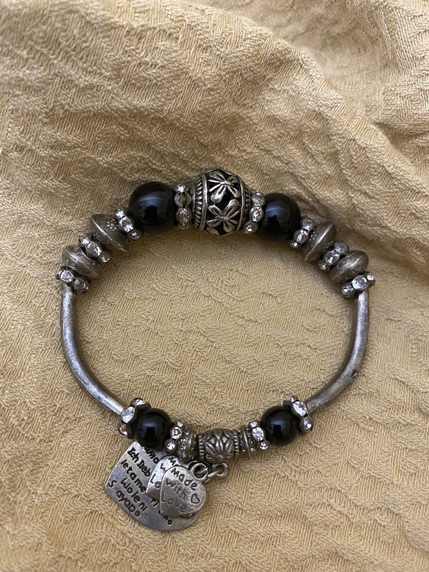 Made with love. Silver and black bead fashion jewelry. Stretch bracelet. Heart charms. Rhinestones.