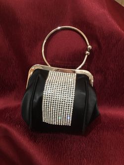 Small wristlet evening purse with rhinestones and hoop handle. An every woman’s must have in your collection. Fourteen rows of beautiful sparkling r