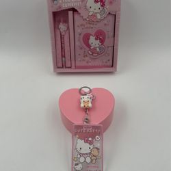 Happy holiday special hello Kitty notepad with pen and hello Kitty keychain ID holder