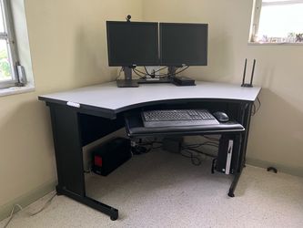 Corner office desk with dual monitors