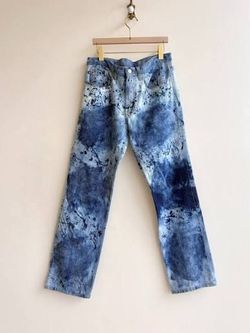 Distressed blue denim jeans