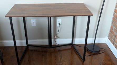 Desk with foldable frame for easy transportation and storage