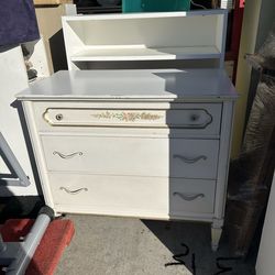 white French Provincial style three-drawer dresser with floral accents