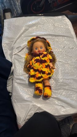 Older doll with crocheted clothes