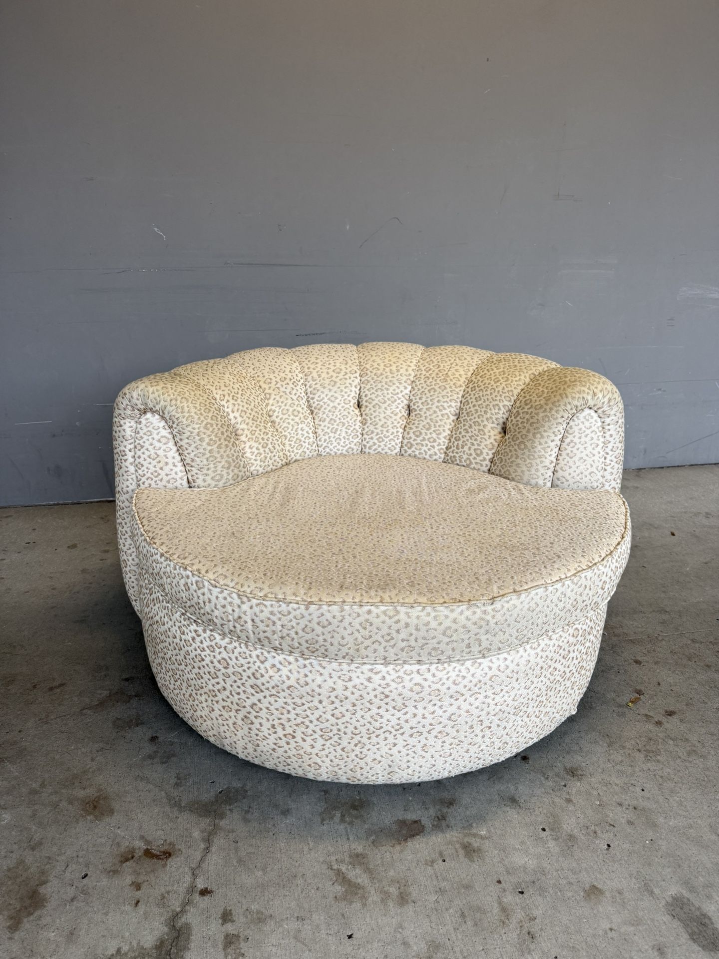 Sofa Ottoman .Vintage armchair with leopard print and ottoman, made in the style of the mid-century or the Hollywood Regency