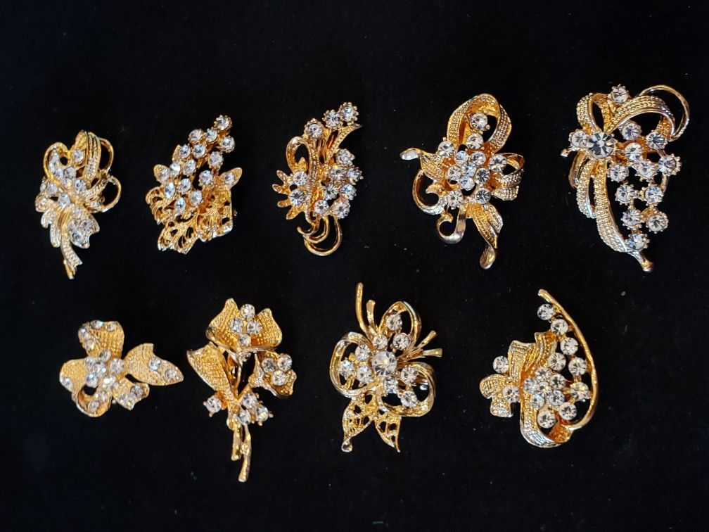 $15. NINE brooches for $15 total! Gold-plated with glass rhinestones. All nine are different. They are not antique or vintage but they look it.
