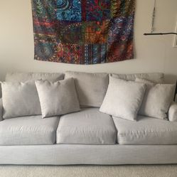 Couch in remarkable condition, slightly used for 6 months. Light grey. Legs and pillows included. 