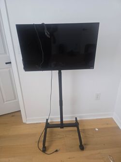 32 inch Vizio TV with stand and Roku device.