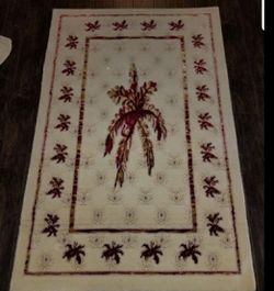 2 red and cream turkish rugs with gold accents
