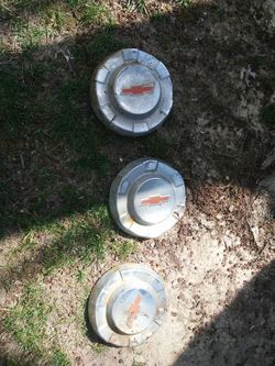 Three chevy hub caps