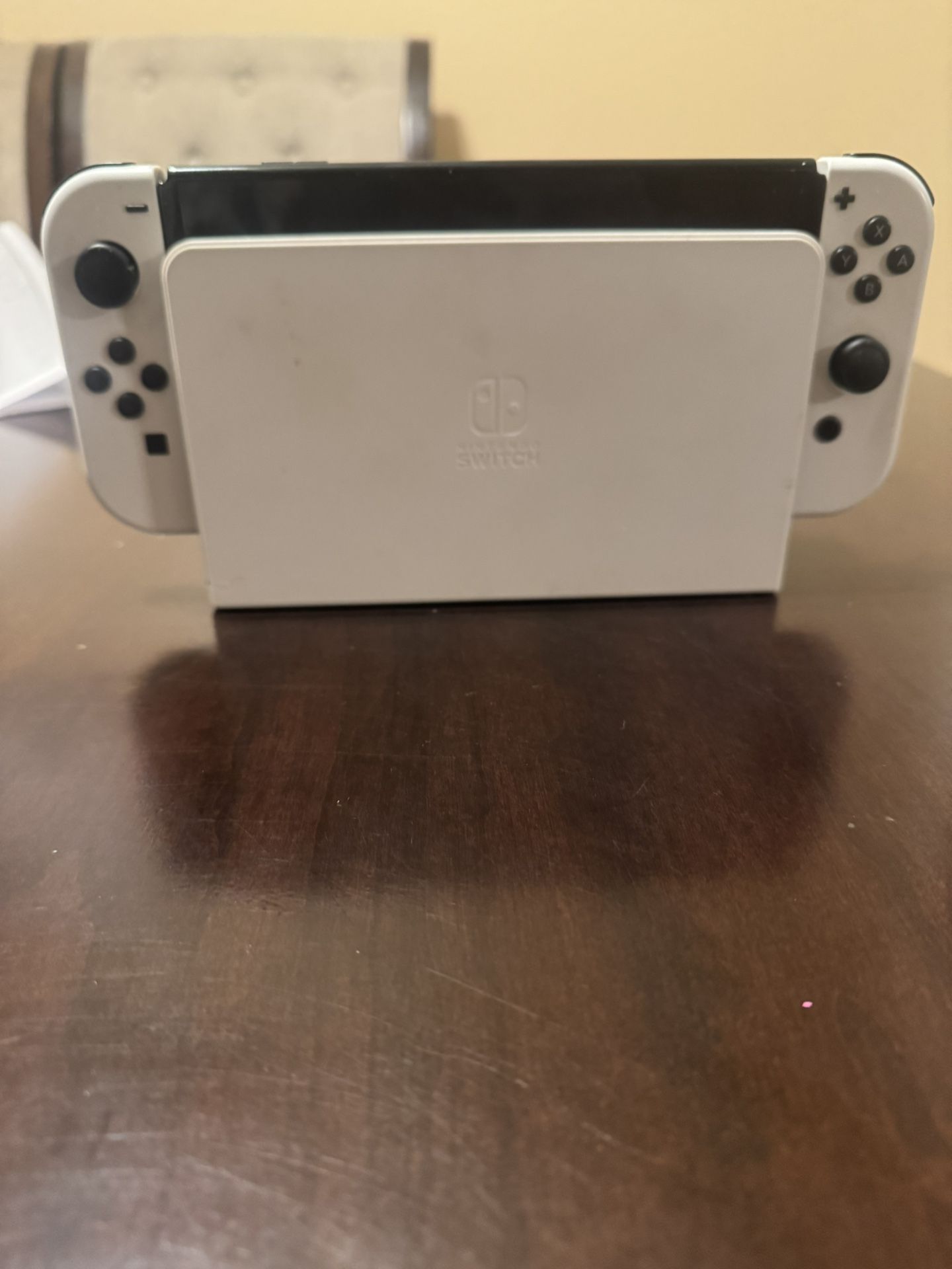 Nintendo switch OLED with two extra controllers, a switch case
