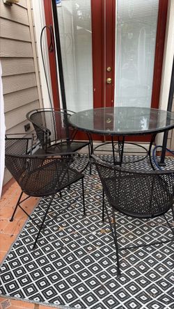 Wrought iron table with three chairs