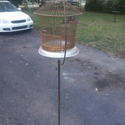 Antique freestanding bird cage with large hoop ring base on cast iron stand, 