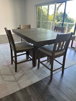Bar height dining table + four upholstered chairs