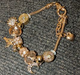 Stunning gold plated with gold plated beads and charms with beautiful different gold charms charms as well.