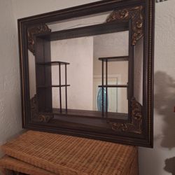 Antique mirror with shelves.