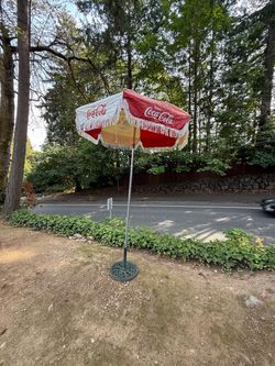 Vintage 1984 Coca-Cola LA Olympics games patio umbrella with heavy cast-iron base