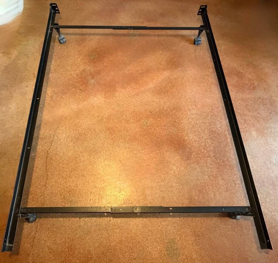 Full-size metal bed frame and headboard with built-in shelf for sale.
