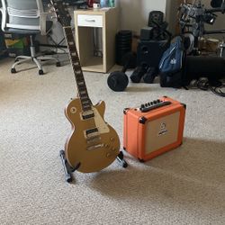 Les paul guitar and orange crush amp