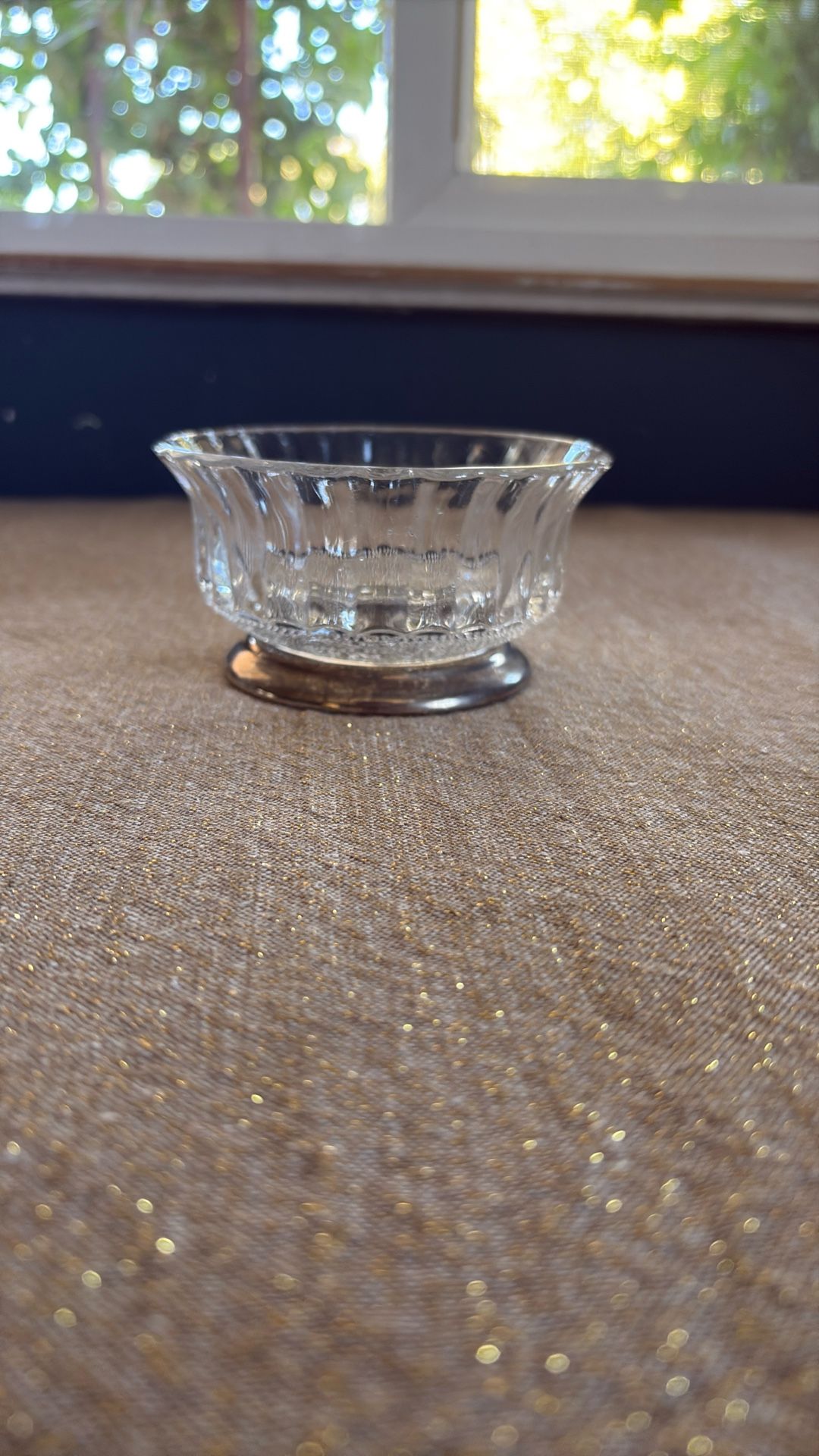 Glass candy bowl with a silver foot