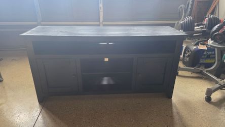 Black TV stand.  $50.00 or best offer.  Ready for pick up asap.