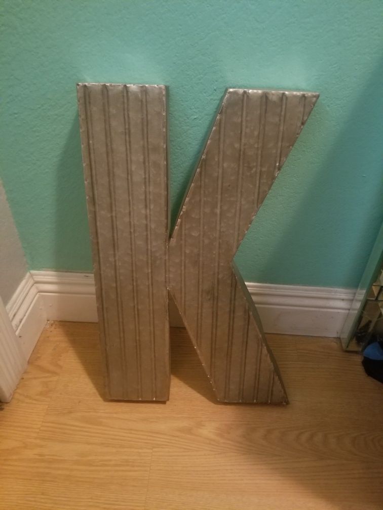 Letter K Sign...Silver metal 20 inches tall by 1 ft wide...Good condition!