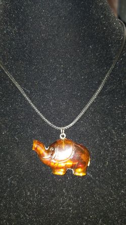 Amber elephant pendant necklace trunks up