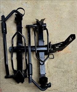 Yakima HoldUp hitch-mounted platform bike rack, likely designed for a 2-inch receiver.Similar models, such as the HoldUp+2, feature wheel-mounted tray