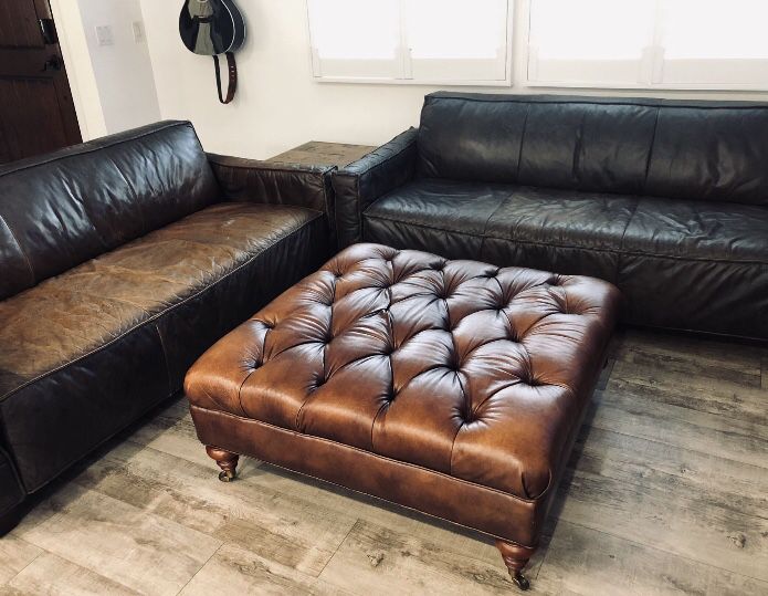 Tufted Genuine Leather Ottoman, Dark Brown, decorative base legs with wheels. Approx 40" x 40" x 18".  In Great Condition.