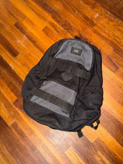 black Vans Planned Pack 3 laptop backpack featuring dual front utility straps and a gray top panel
