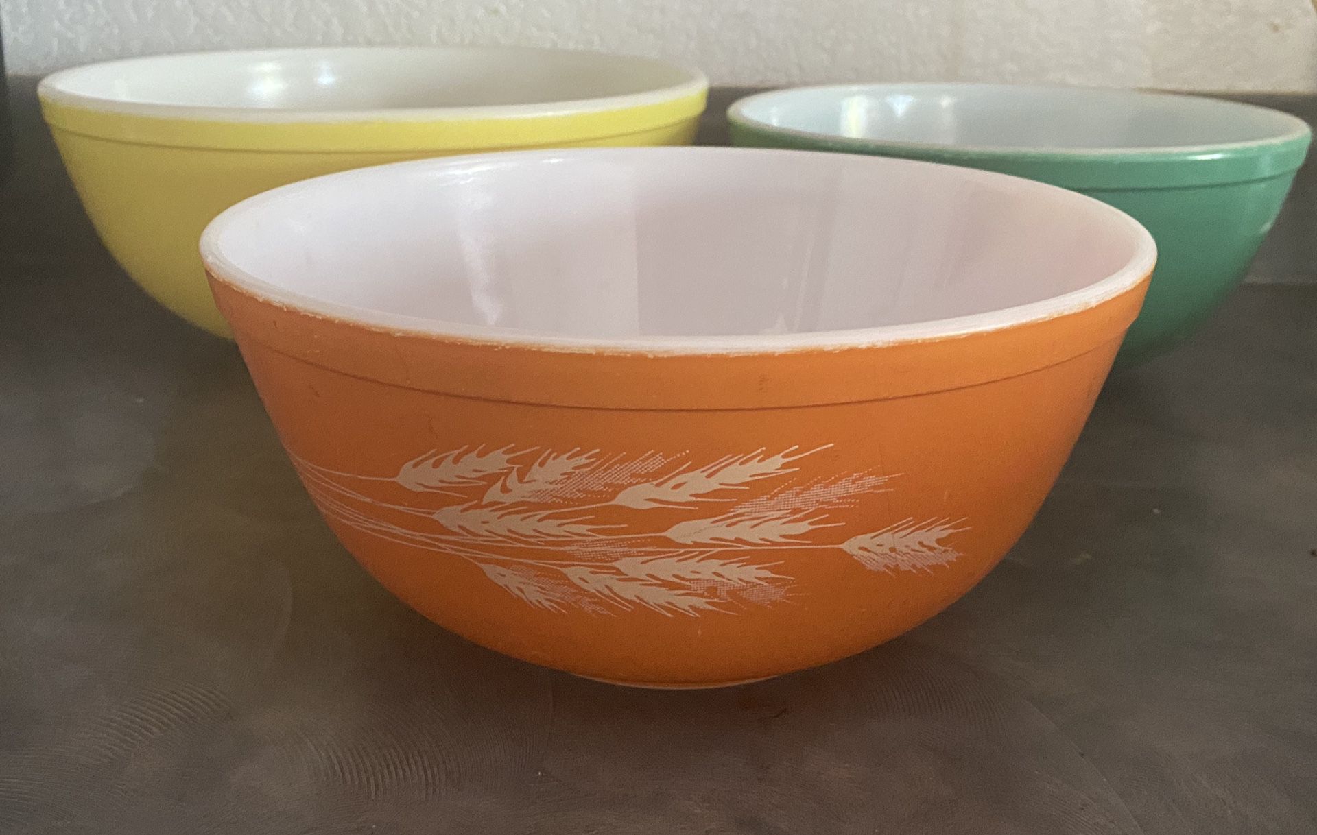 Three large Pyrex bowls
