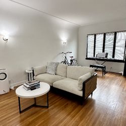 Beige Sofa With Black Trim And Brown Cane