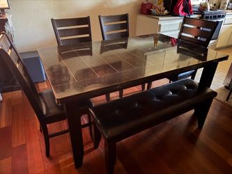 Dinner table with 4 chairs and a bench