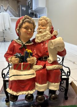 Mr and Mrs Claus statue included metal bench