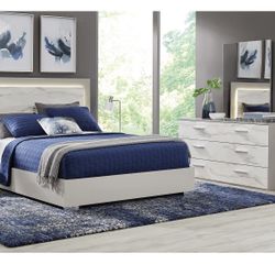 King Bed And A Dresser With A Mirror On