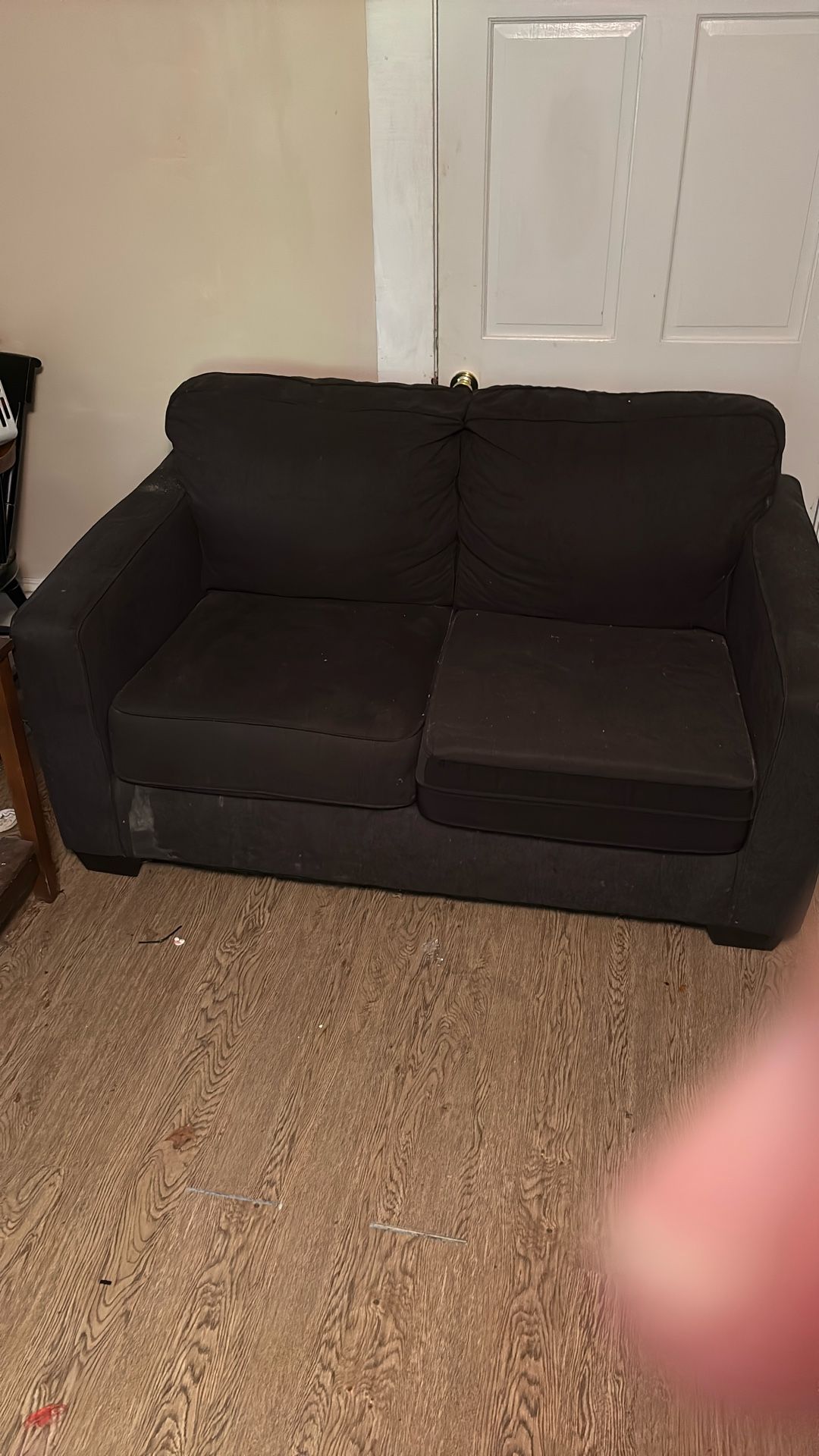 Long black pullout bed, couch, and small, matching couch