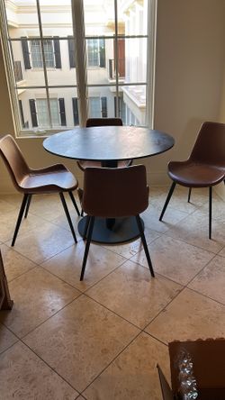 Designer table with an iron leg and a ceramic top