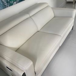 New!!! Power Reclining Loveseat Real Leather, adjustable headrest and footrest. Dimensions 63 W x 33 H x 43.5 L  