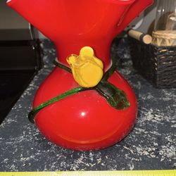 NEW condition vintage art glass vase featuring a bright red body with a ruffled white-cased interior, decorated with an applied yellow flower and gree