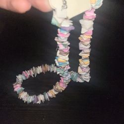    +1 Thispastel clam chip or puka shell necklace often featuring irregular shell-like beads in candy hues