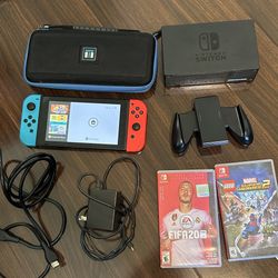 Nintendo Switch Console with joycons, dock, cords, and 2 games