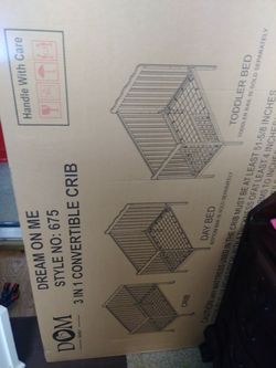 New in a box baby crib with mattress