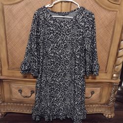 Black and grey dress with ruffle details on sleeve and hemline. By Addressing Women, size large. 