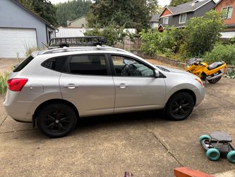 Nissan Rogue Silver SUV with Roof Rack