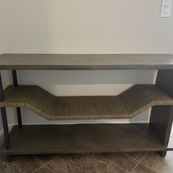 Modern wood console table with lower storage shelf.