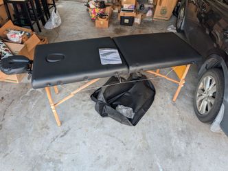 Folding massage table with head rest